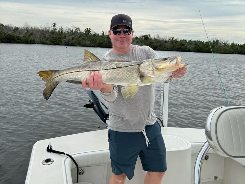 A man with his catch on the back of a charter fishing boat in Sarasota, Florida