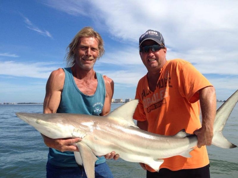 A couple with their catch on the back of a boat in Sarasota, Florida