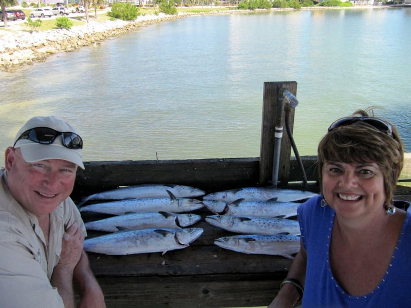 Two women taking a selfie with their catch on the dock in Sarasota, Florida