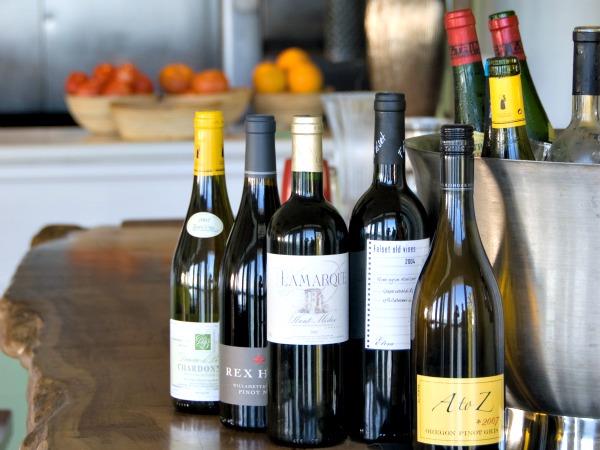 bottles of wine on an antique table at Louies Backyard in Key West