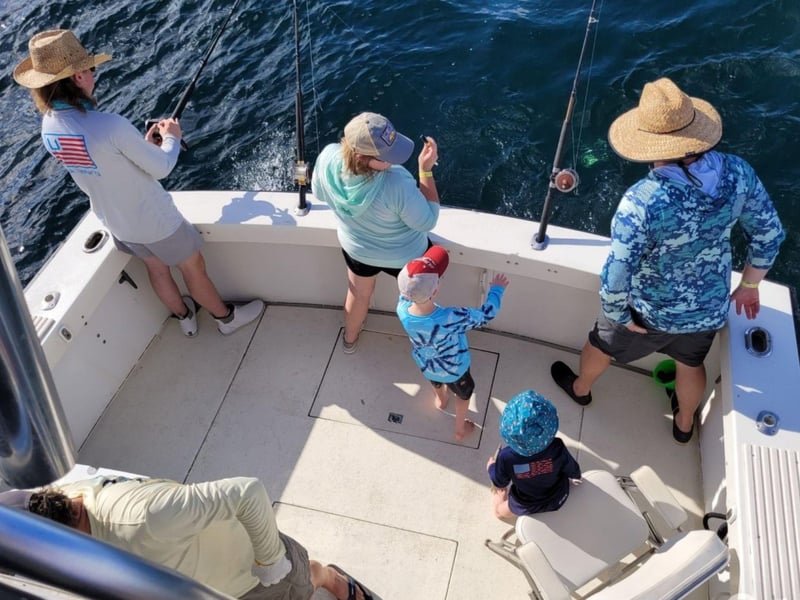An overhead view looking down at a family fishing off Alibi 2
