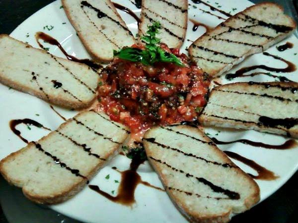 Vinnie Rs bruschetta with roma tomatoes, garlic, basil and balsamic vinegar
