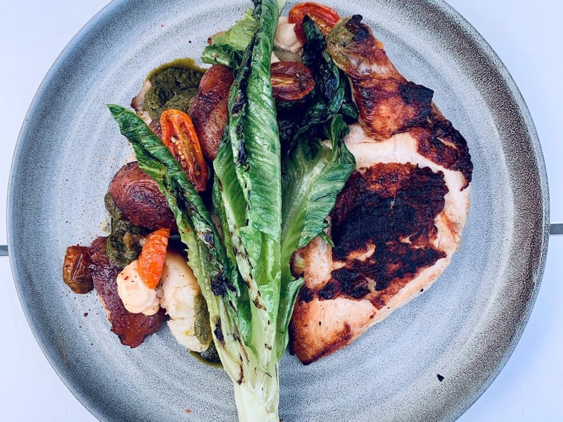 Chicken breast with grilled romaine and crispy potatoes  at Caliza Restaurant