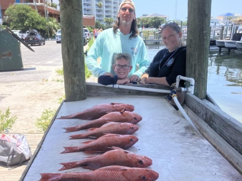 A family with their fish on the dock