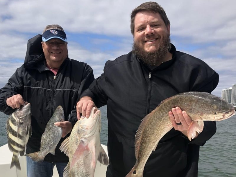 A couple with their catches fom Russells Coastal Fishing Charter