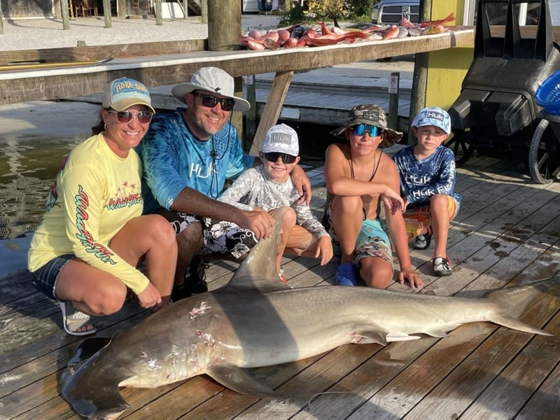 A family on the dock with their catch in Orange Beach, Alabama