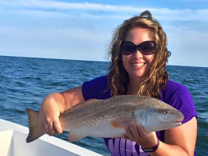 A woman with her catch aboard Miss Caymen