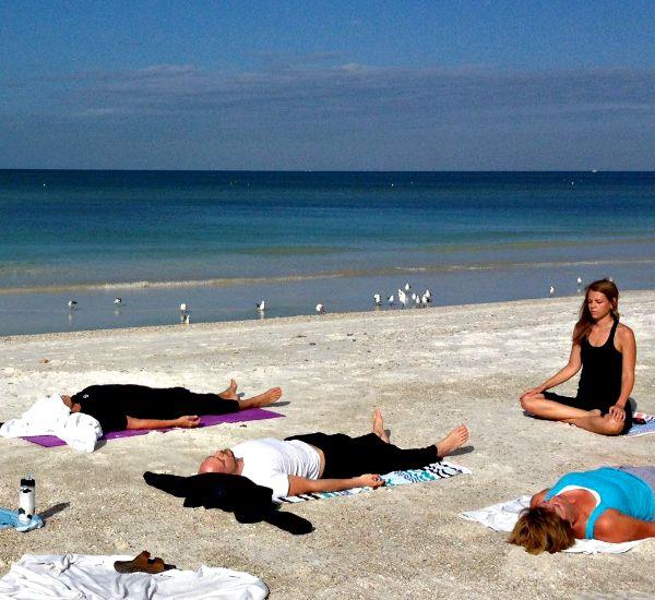 Aluna Wellness Center Anna Maria Island group yoga class on the beach
