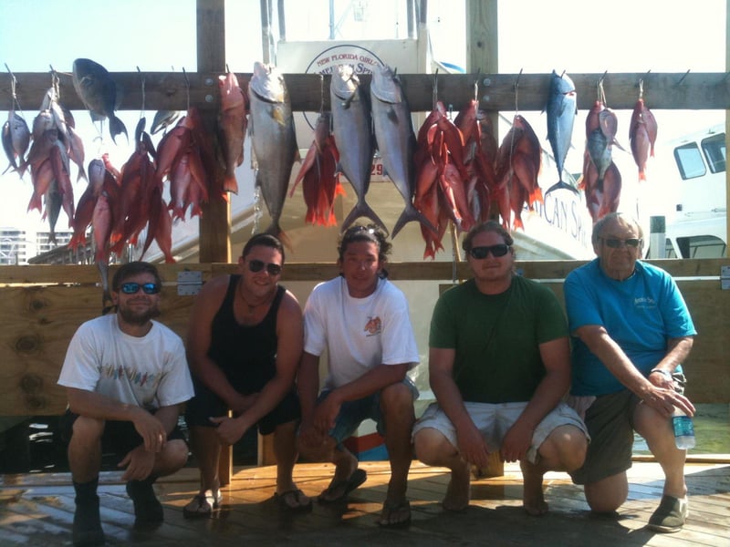 A groups shows off their catches from American Spirit on the dock in Destin, Florida