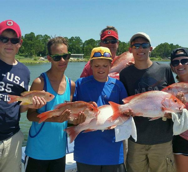 Teens catching Mingo and Lane snapper aboard Bay View Charters on St. George Island
