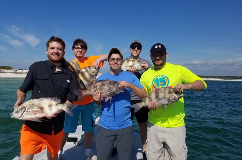 A group showing off their catch on board Cant Quit Fishin