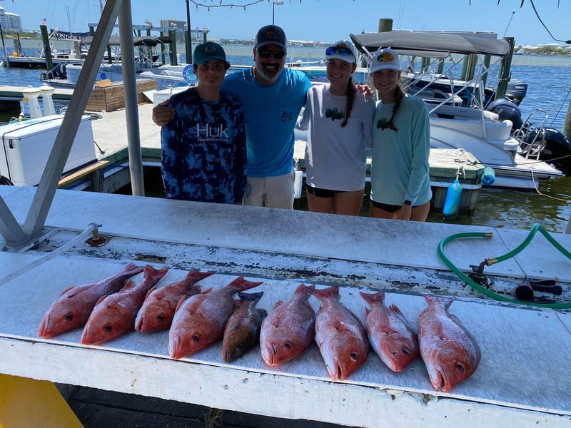 A group on the dock with their catch from Strickly Fishing Charters