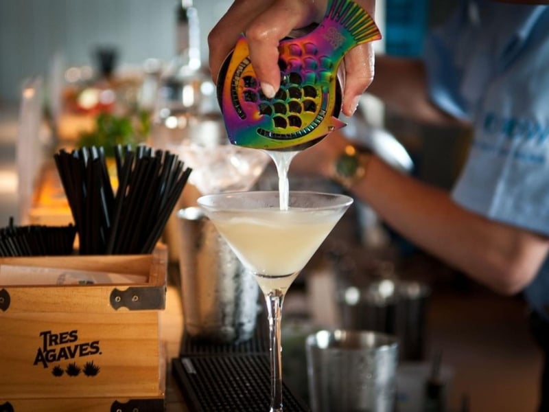 A bartender pouring a cocktail at Fish Out of Water