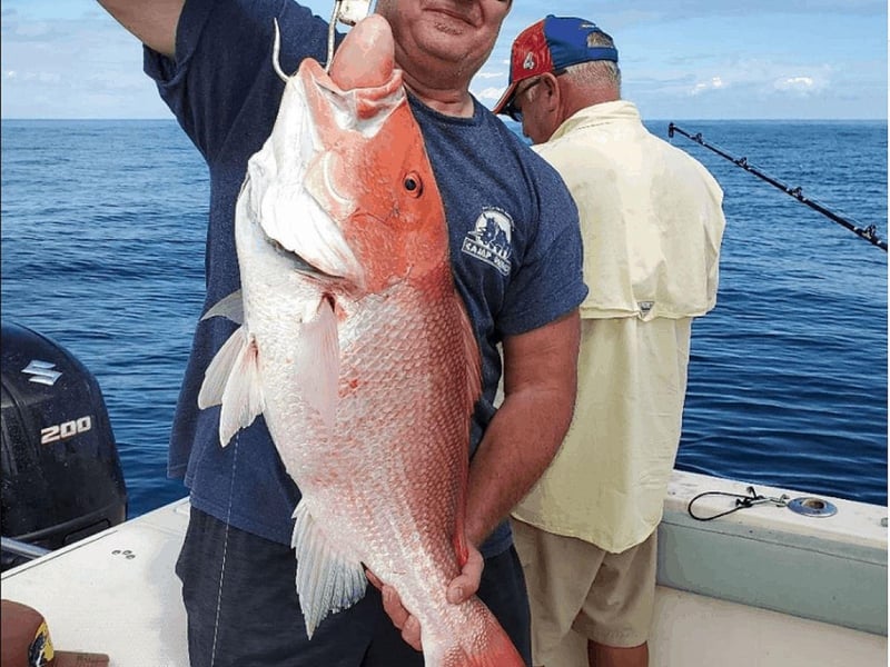 An angler with a large red snapper