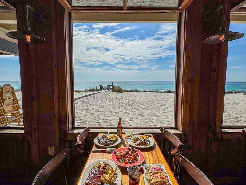 A table by the window overlooking the beach at Surf Hut