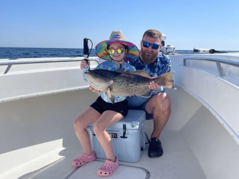 A family with their catch on board Strictly Business in Santa Rosa Beach, Florida