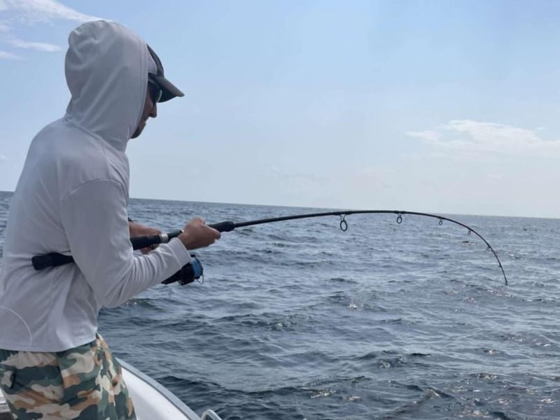 A man fishing off of Strictly Business in Santa Rosa Beach, Florida