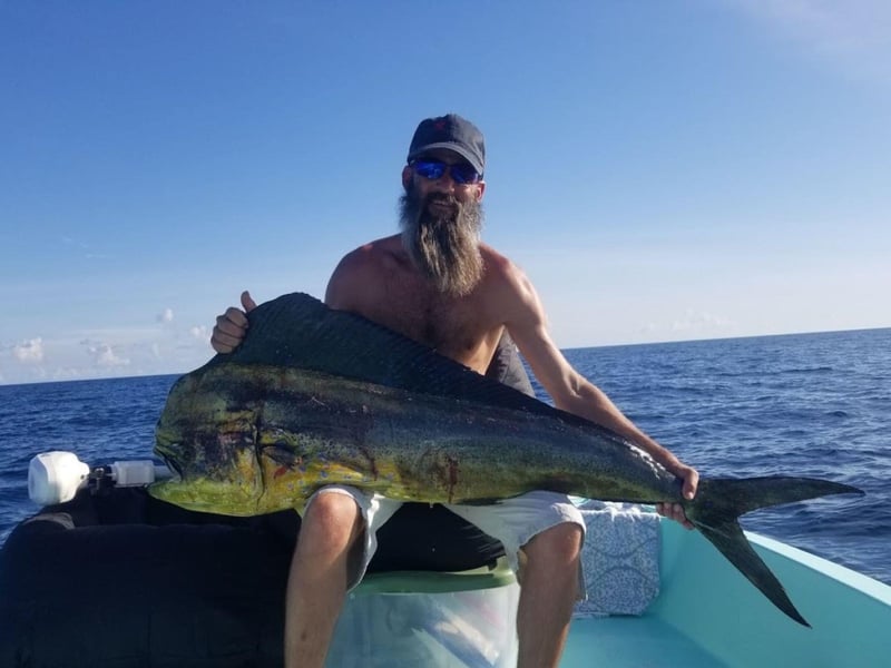 A man holding his catch on Get the Gaff in Destin, Florida