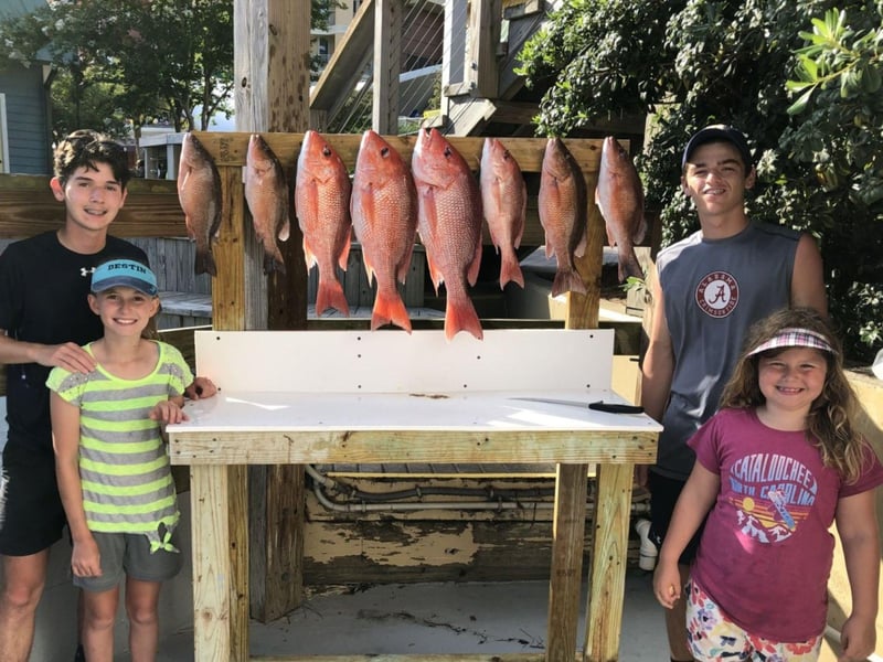 A family with their catch on the dock in Destin, Florida