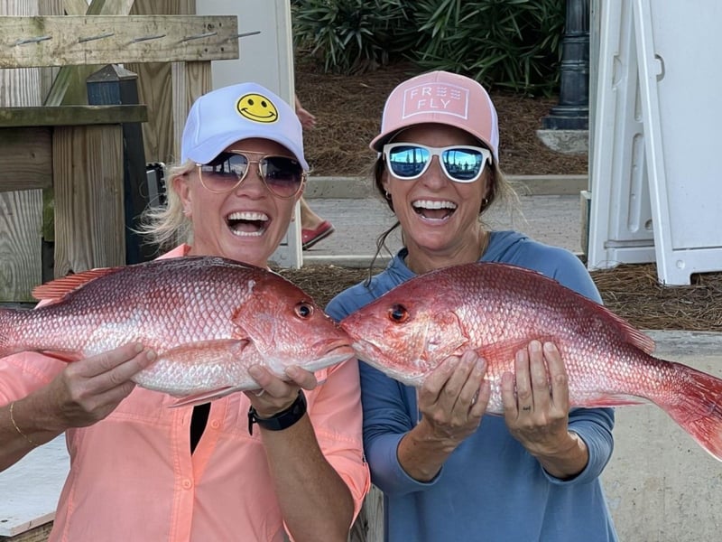 Two girls showing off their catch from Karma Charters LLC in Destin, Florida