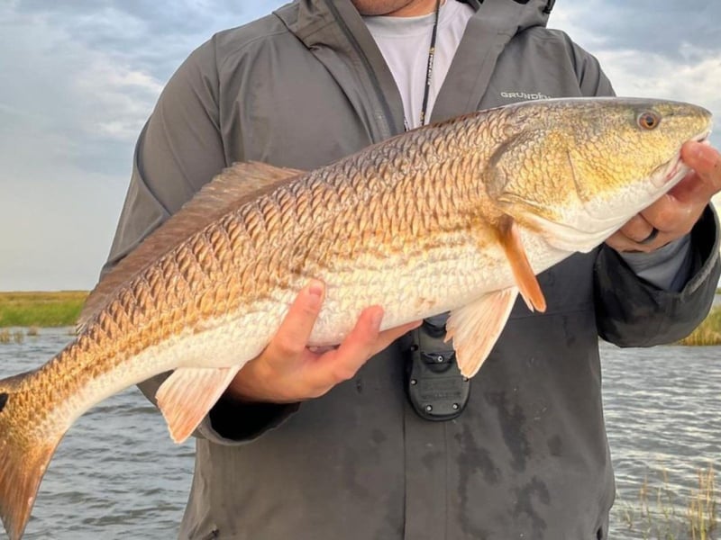 A man with his catch from Calibrated Fishing Charters