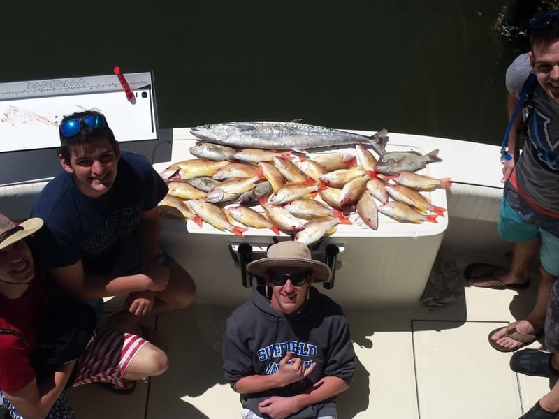 A group on the back of the boat with their catches in Sarasota, Florida