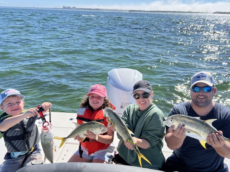 A family on the back of the boat with Get Salty Charters in Sarasota, Florida