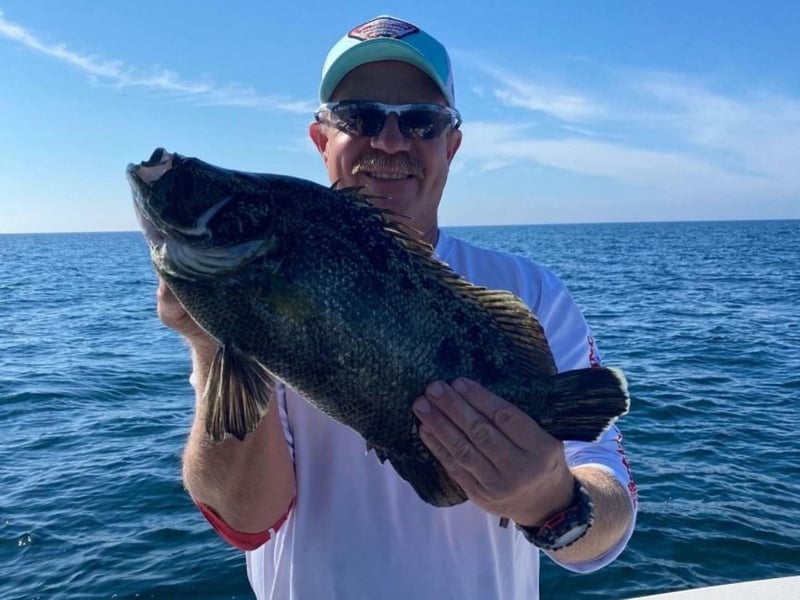 A man showing off his catch from Get Salty Charters