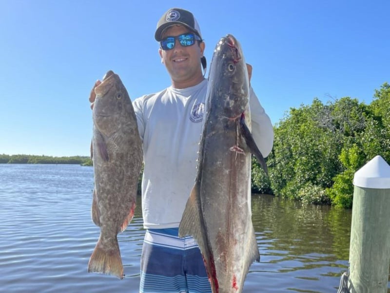 A man showing off his catch on the dock in Sarasota, Florida