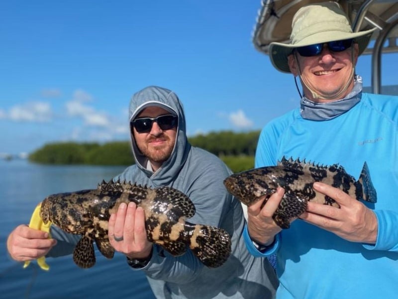Two men showing off their catch from Stellar Action Fishing Charters in Sarasota, Florida