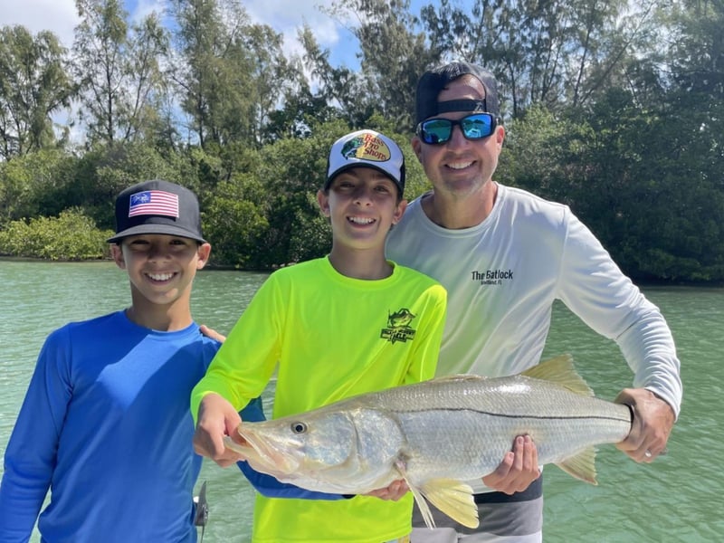 A family showing off their catch on the water in Sarasota, Florida