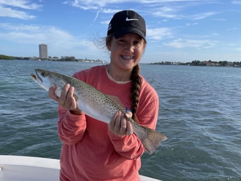 A woman showing off her catch from James Gibson Charters LLC in Sarasota, Florida
