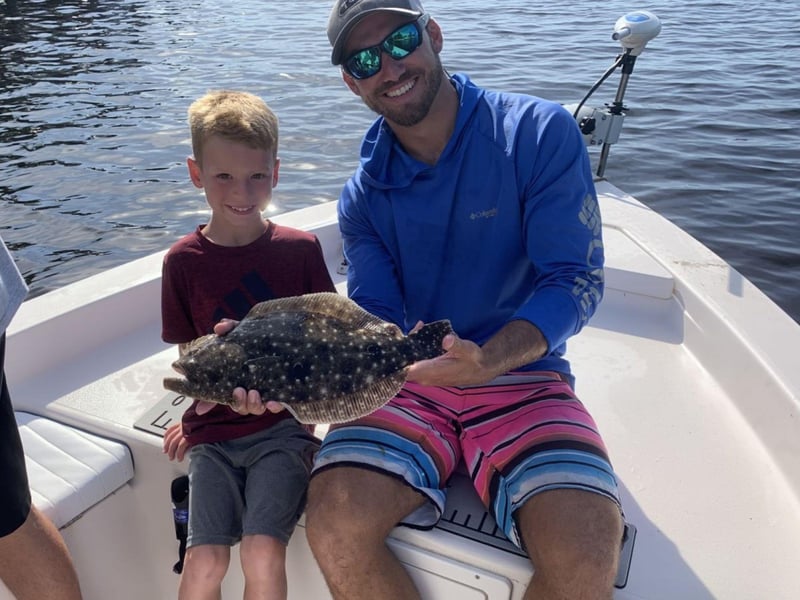 A son and his father with their catch on the boat in Sarasota, Florida