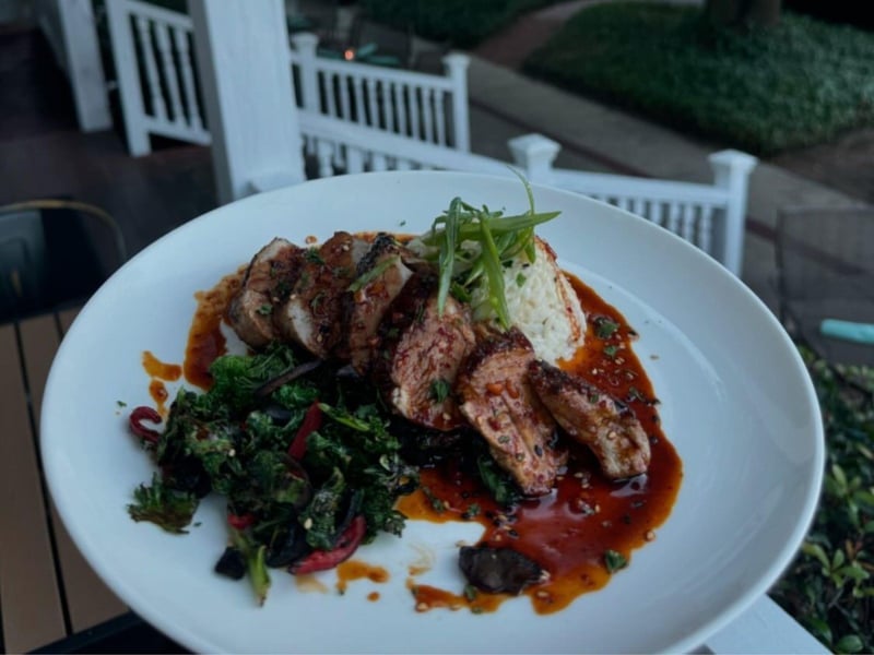 Grilled pork tenderloin, kale  mushroom stir fry, ginger scallion rice, topped with a chili garlic demi glaze