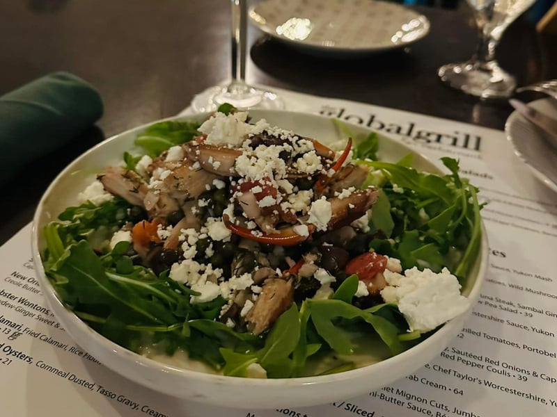 Crab claws on a bed of arugula from The Global Grill in Pensacola, Florida