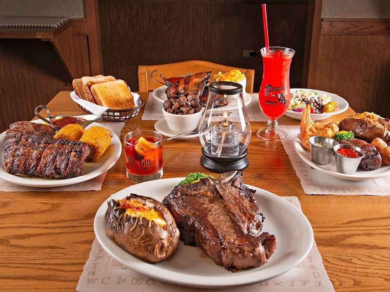 Multiple entrees on a table at Angelos Steak Pit in Panama City Beach, Florida
