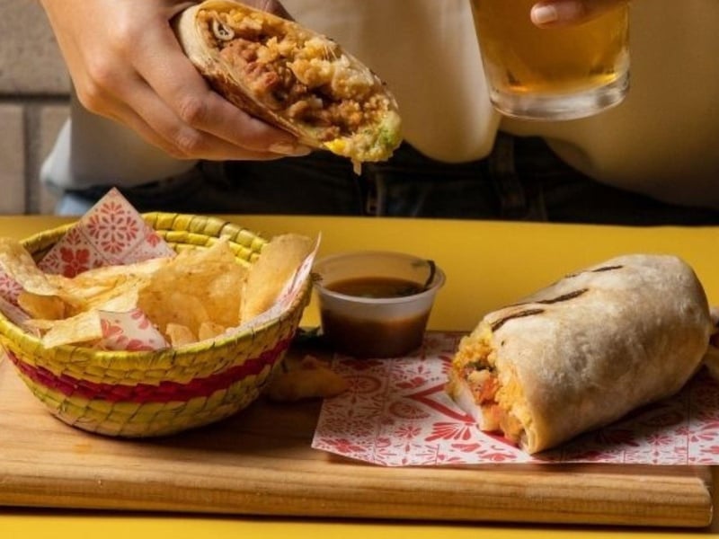 A burrito with chips and salsa at Senor Frogs