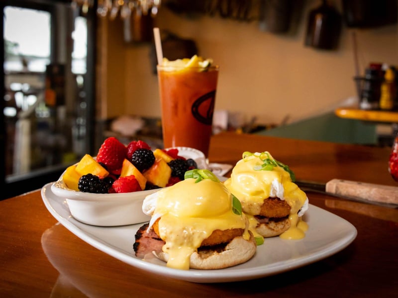 The eggs benedict with fruit and a bloody mary