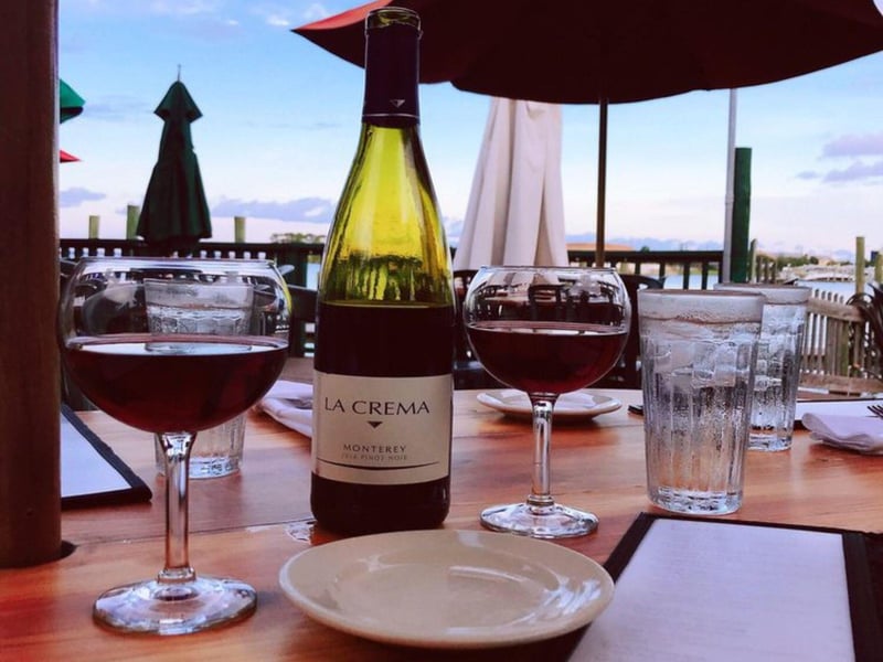 A wine bottle with glasses from Bay Cafe French Restaurant