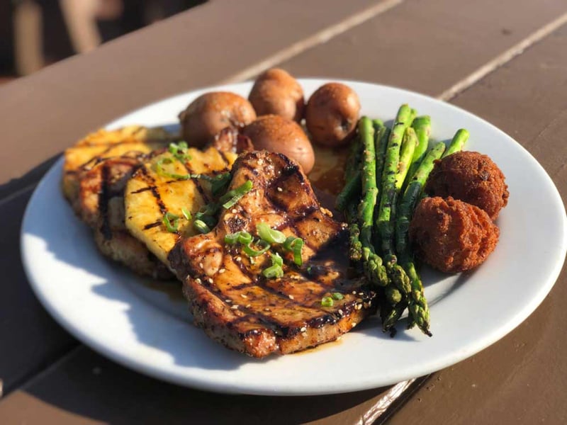 Hawaiian pork chops with potatoes, asparagus and hushpuppies
