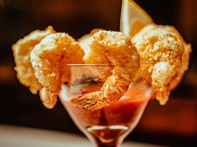 Fried shrimp served with cocktail sauce from Alis Bistro