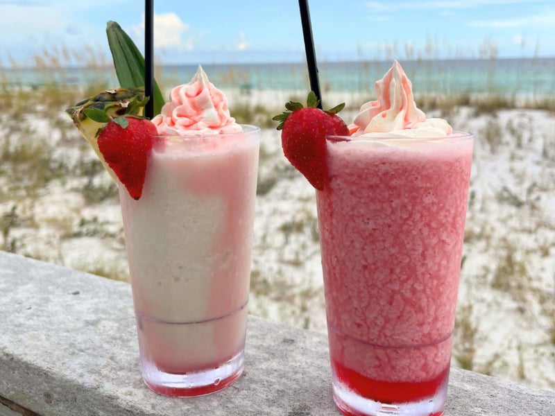Two frozen cocktails on the beach at The Remedy
