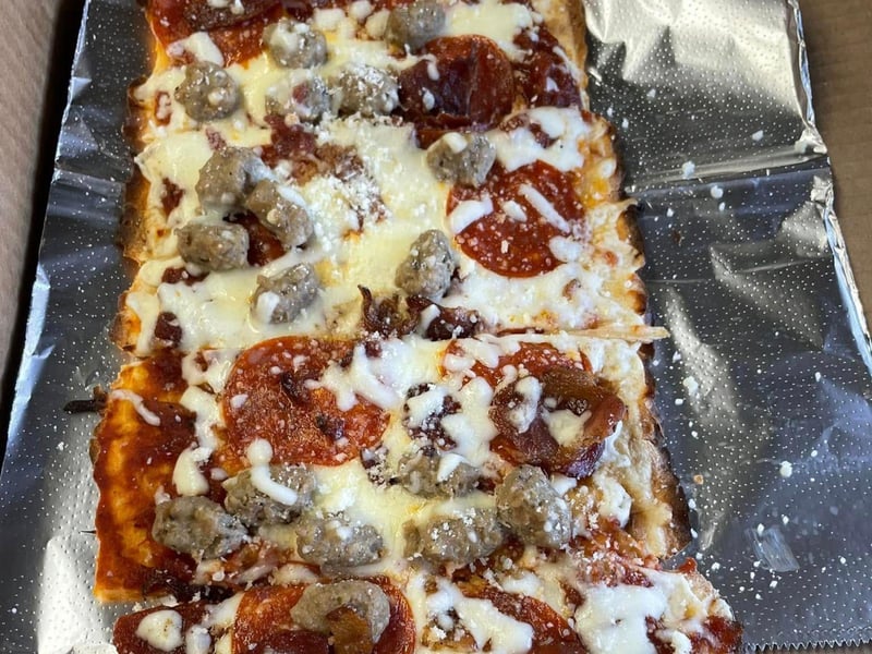 A meat lovers pizza with pepperoni, sausage and bacon