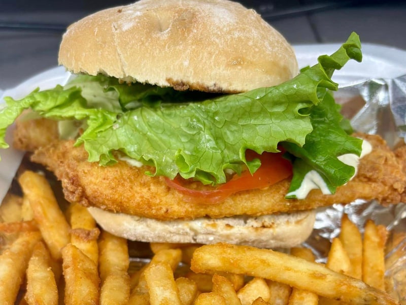 A fried fish sandwich with french fries