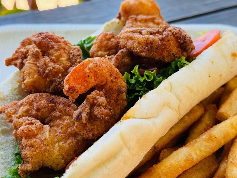 A fried shrim poboy with french fries