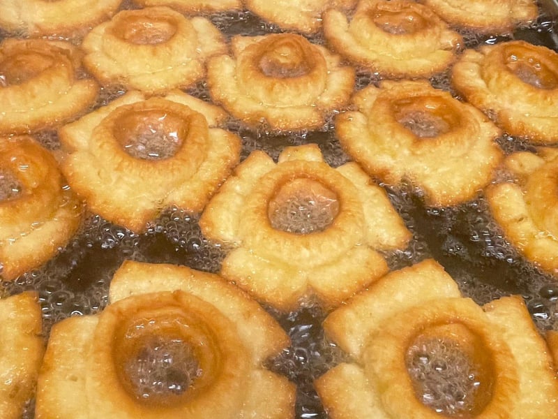 Frying cake donuts at Webers Little Donut Shop