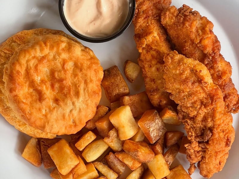 Chicken tenders with a biscuit and potatoes