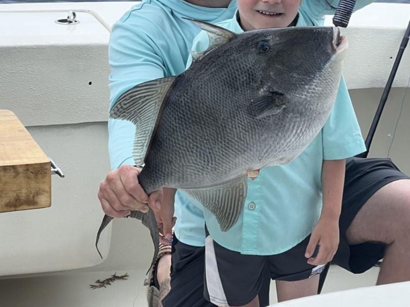 A kid with his catch on First Light in Destin, Florida