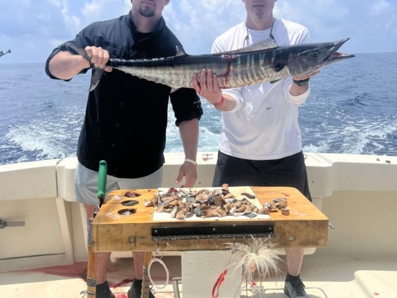 Two anglers showing off their catch