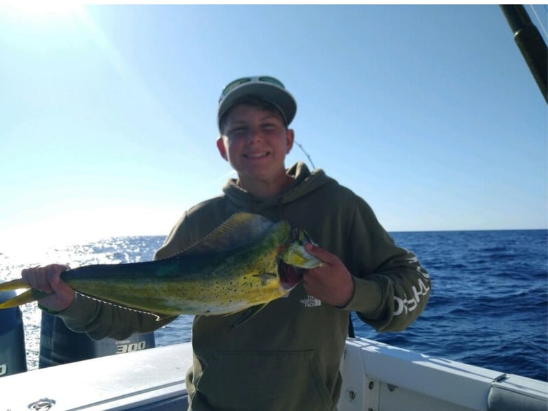A kid with his catch onboard First Light